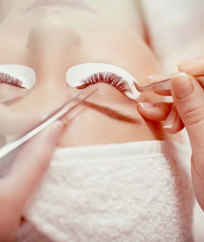 View from above of stylist lengthening lashes. temporary lashes