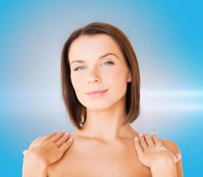 beauty, spa, health and people concept - beautiful woman touching her shoulders
